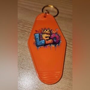 Orange Leo Keychain with Graffiti Design
